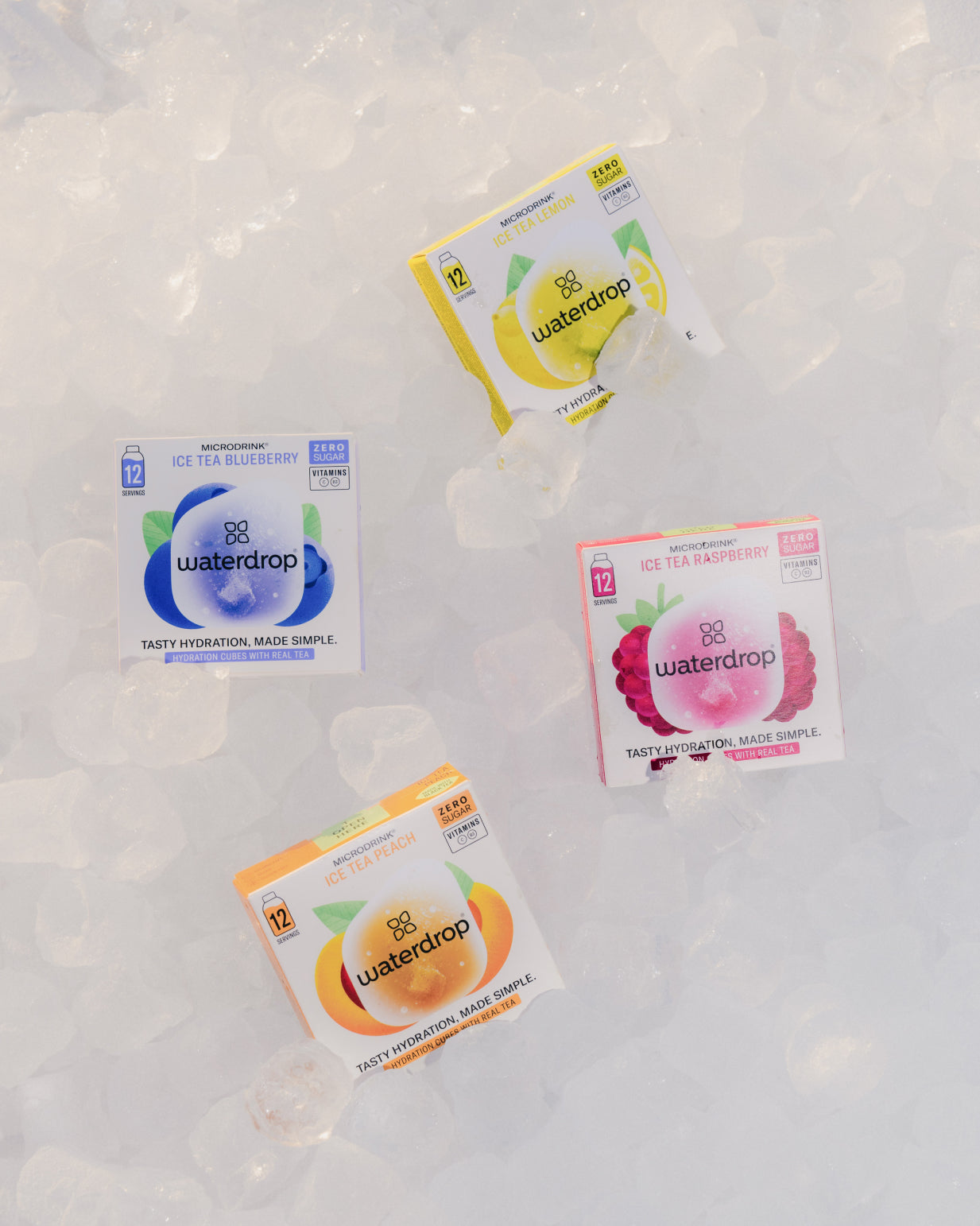 ICE TEA Set with boxes of Lemon, Peach, Blueberry, and Raspberry flavors on ice, highlighting waterdrop®'s hydration solutions.