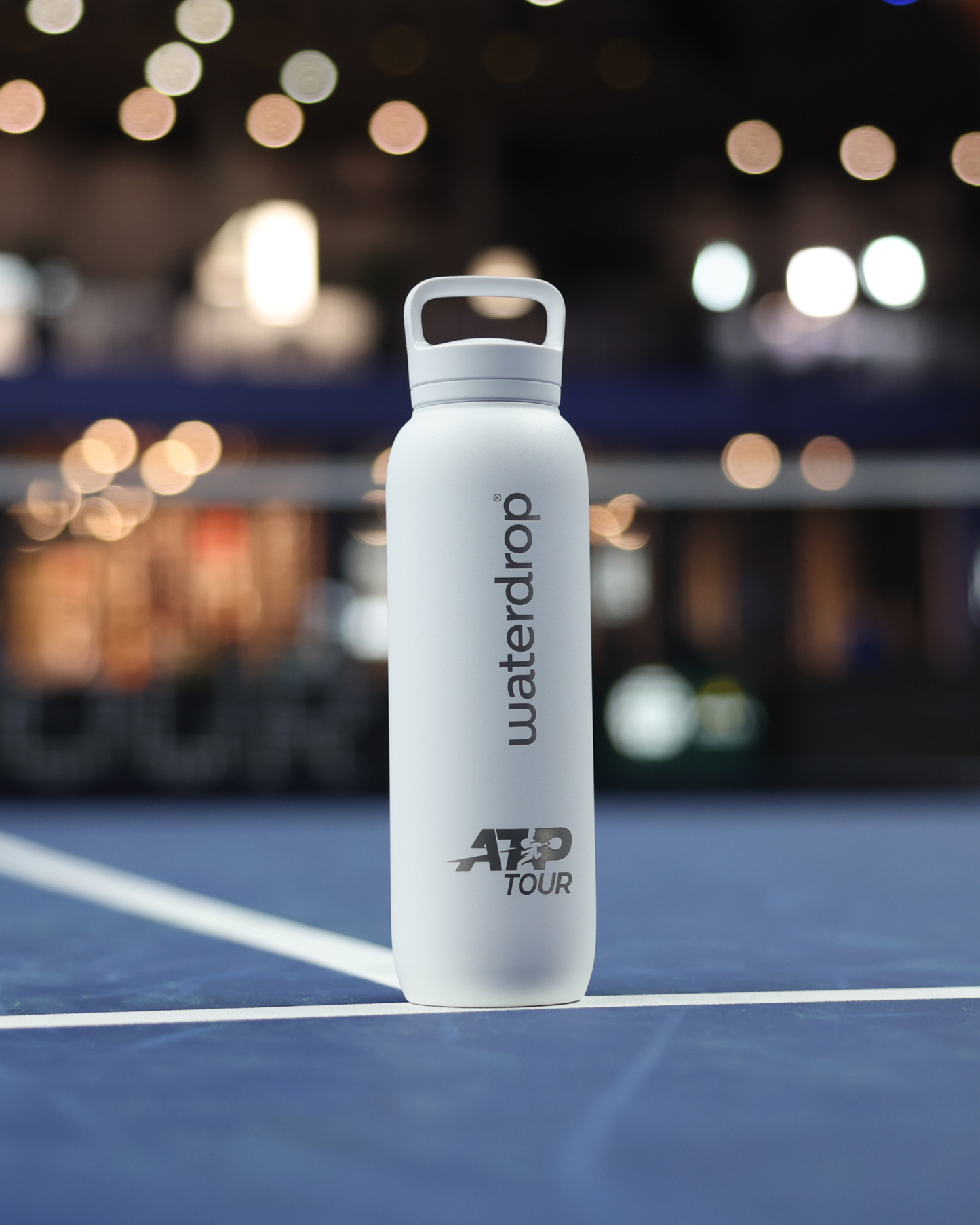 Official ATP Tour waterdrop all-purpose Thermo with Spout Lid on tennis court, designed for professional players, featuring co-branding and ice cube compatibility for optimal hydration.