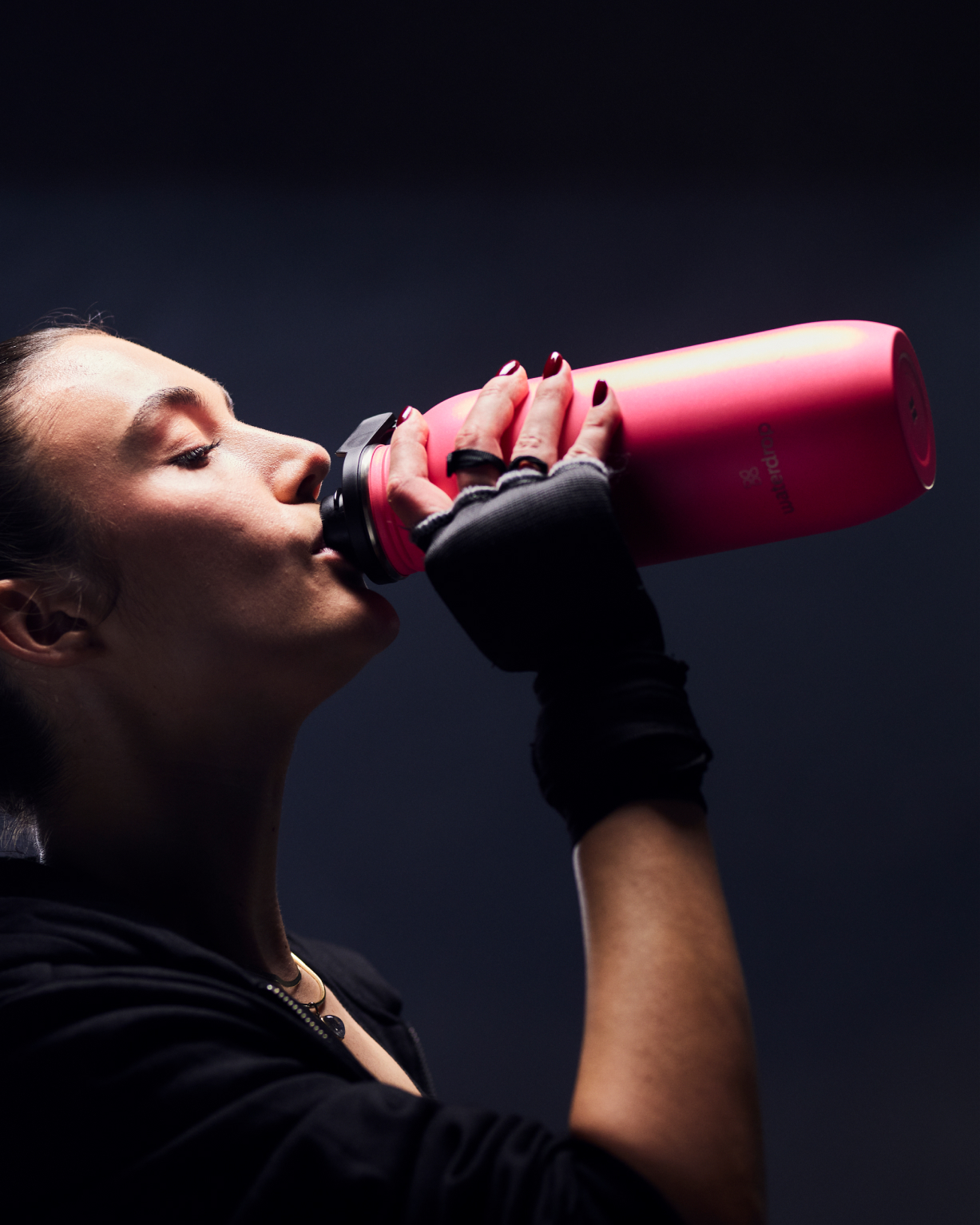 Woman drinking from an All-Purpose Ultralight Bottle with Swing Lid, ideal for excursions and everyday use.