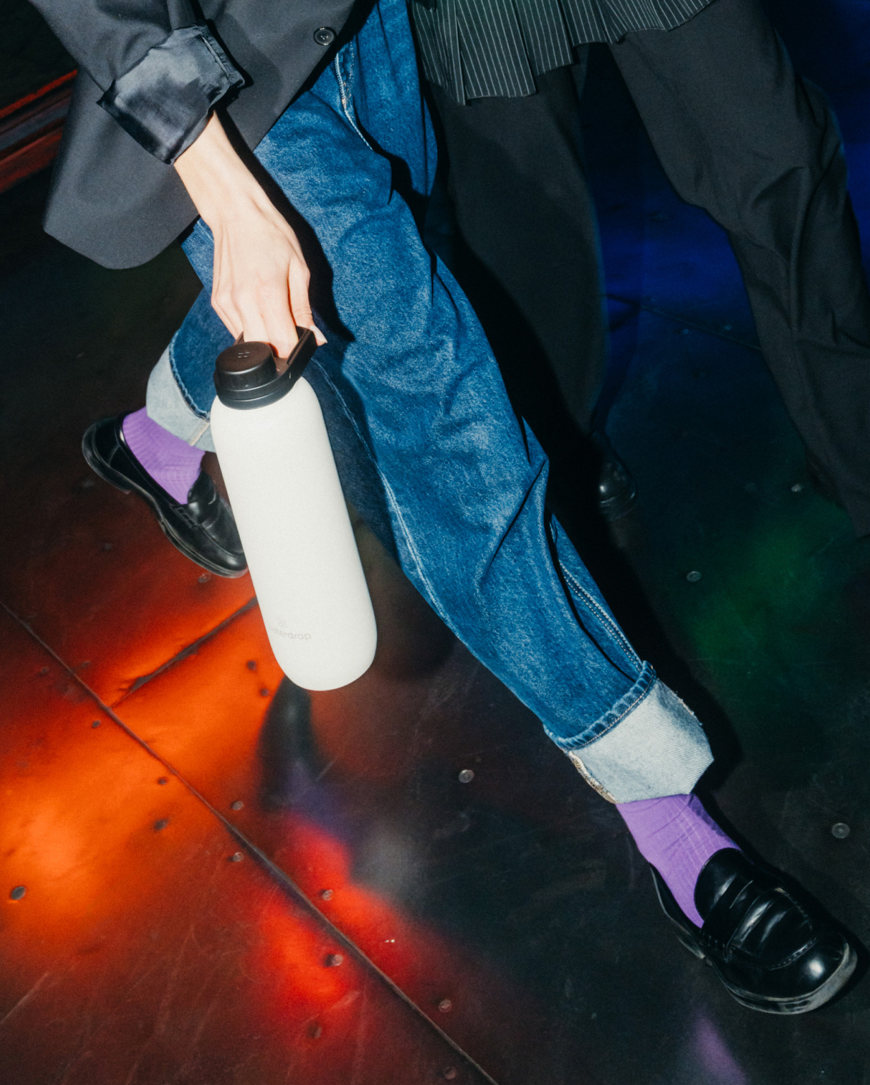 A person holding the All-Purpose Thermo · Swing Lid bottle, showcasing its vacuum-insulated design for 24-hour cold refreshment.