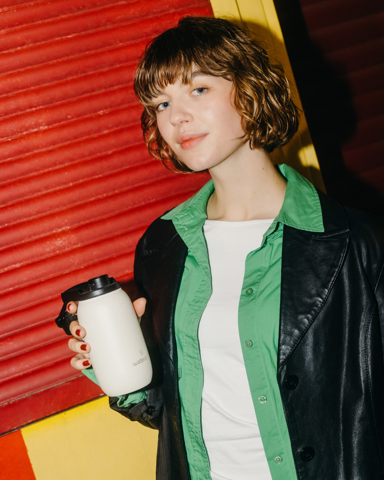 Woman holding the All-Purpose Thermo with Swing Lid, showcasing its practical design for hydration on the go.