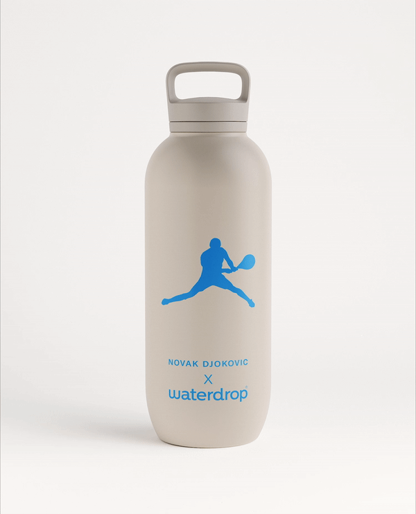 Novak Djokovic All-Purpose Thermo Spout Lid bottle with a blue logo, featuring a blue tennis player silhouette, ideal for keeping drinks cold for 24 hours.