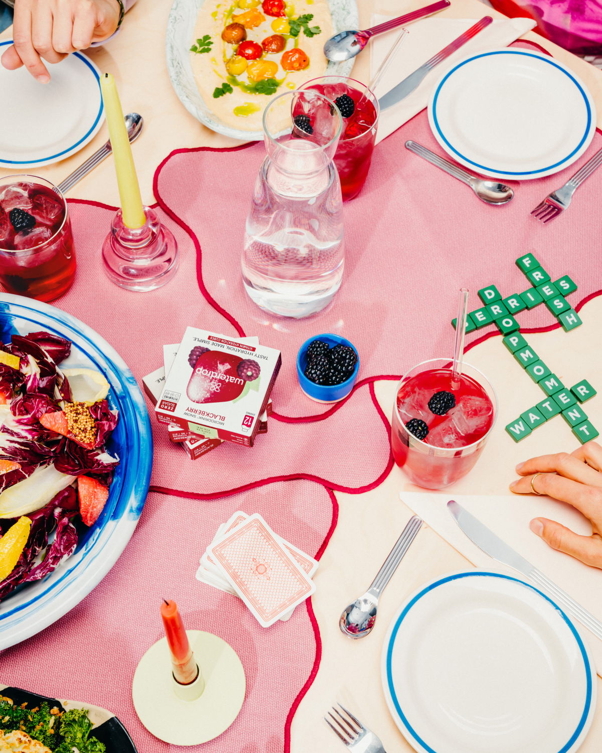 A table set with food and drinks, featuring Microdrink BLACKBERRY with blueberries.