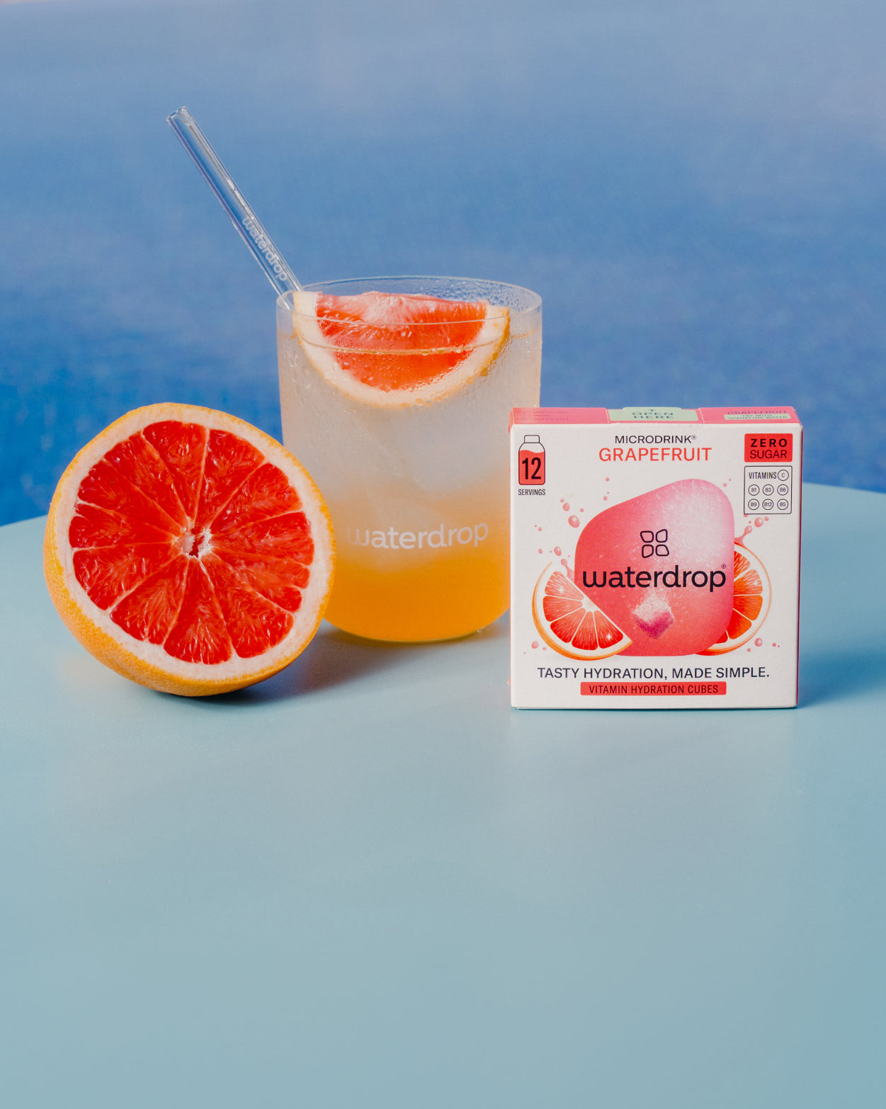 GRAPEFRUIT: A half grapefruit, a glass of grapefruit juice with orange slices, and a waterdrop® juice box. Enjoy bold flavor, no sugar.