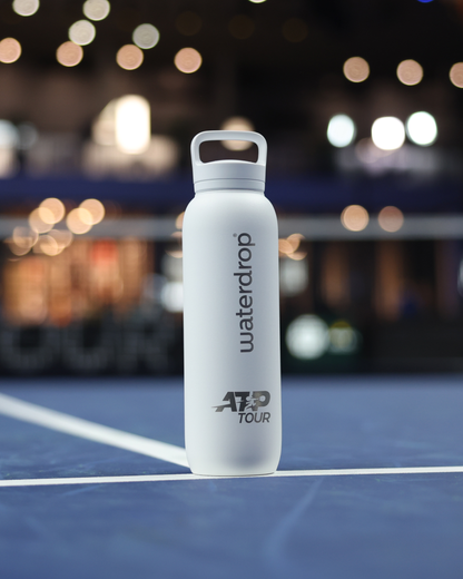 Official ATP Tour waterdrop all-purpose Thermo with Spout Lid on tennis court, designed for professional players, featuring co-branding and ice cube compatibility for optimal hydration.