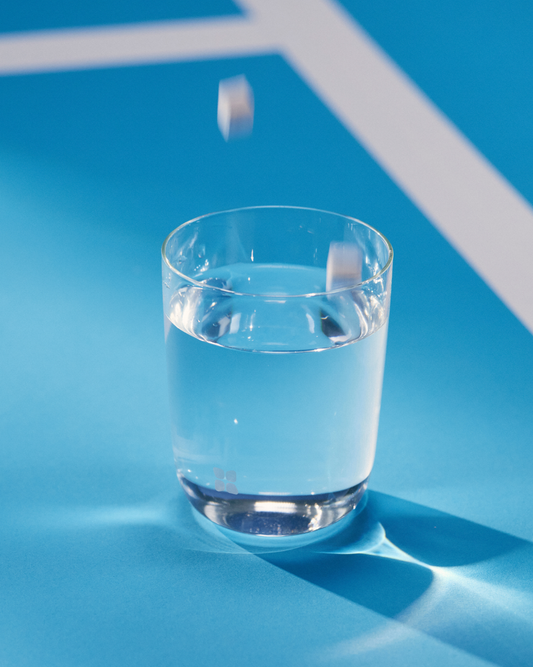 SILA Hydration Set featuring a glass of water and electrolyte cubes, designed for convenient hydration and electrolyte replenishment.