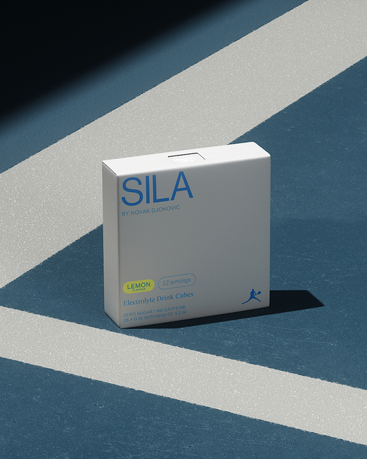 SILA Lemon electrolyte box on a blue and white surface, featuring blue text and a person holding a tennis racket illustration.