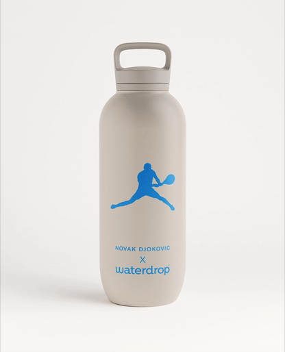 Novak Djokovic All-Purpose Thermo Spout Lid bottle with a blue logo, featuring a blue tennis player silhouette, ideal for keeping drinks cold for 24 hours.