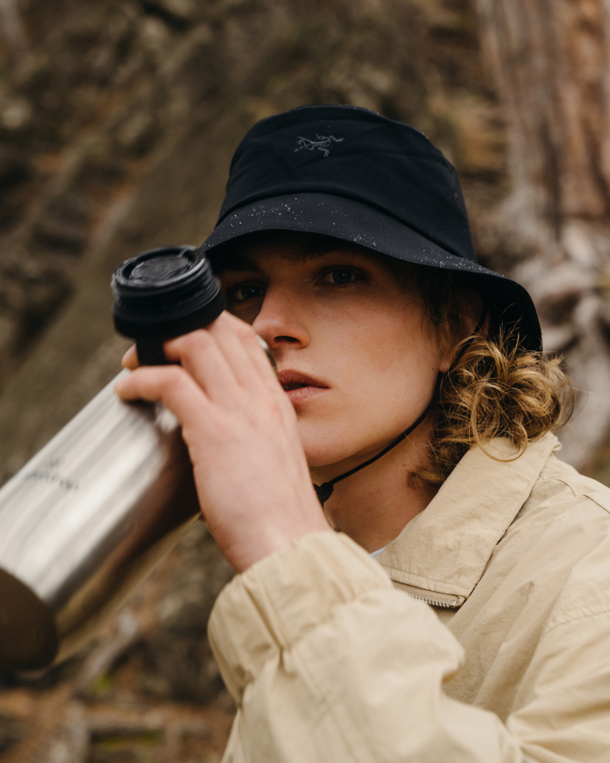 Person drinking from an All-Purpose Ultralight · Loop Lid bottle, featuring a practical thermal lid with a carrying loop, ideal for hikes and daily use.